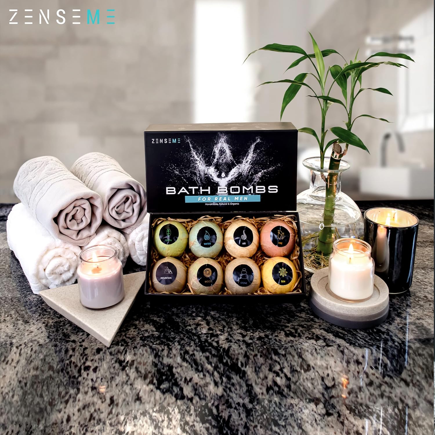 Bath bombs in a box with towels and candles on a countertop, featuring the ZENSEME brand.